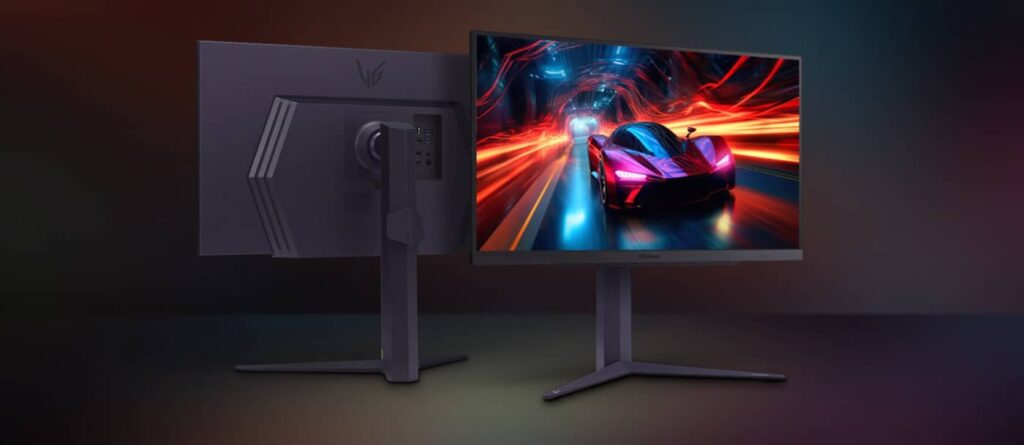 Dual-monitor setup: back view of a large gray monitor on a stand and a front-facing monitor displaying a neon racing game scene with a red sports car.